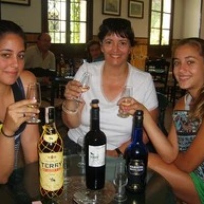 a group of people sitting at a table drinking wine