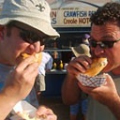a man wearing glasses eating a donut