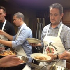 a group of people preparing food in a kitchen