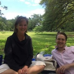 a group of people sitting at a picnic table