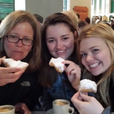 a group of people sitting at a table eating food