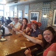 a group of people sitting at a table in a restaurant