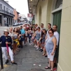 a group of people walking on a sidewalk