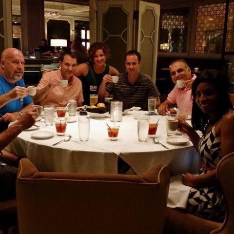 a group of people sitting at a table in a restaurant