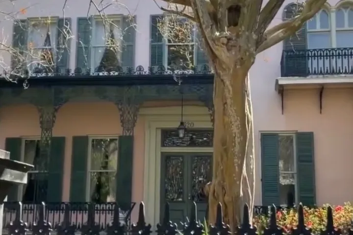 a vase of flowers sits in front of a building