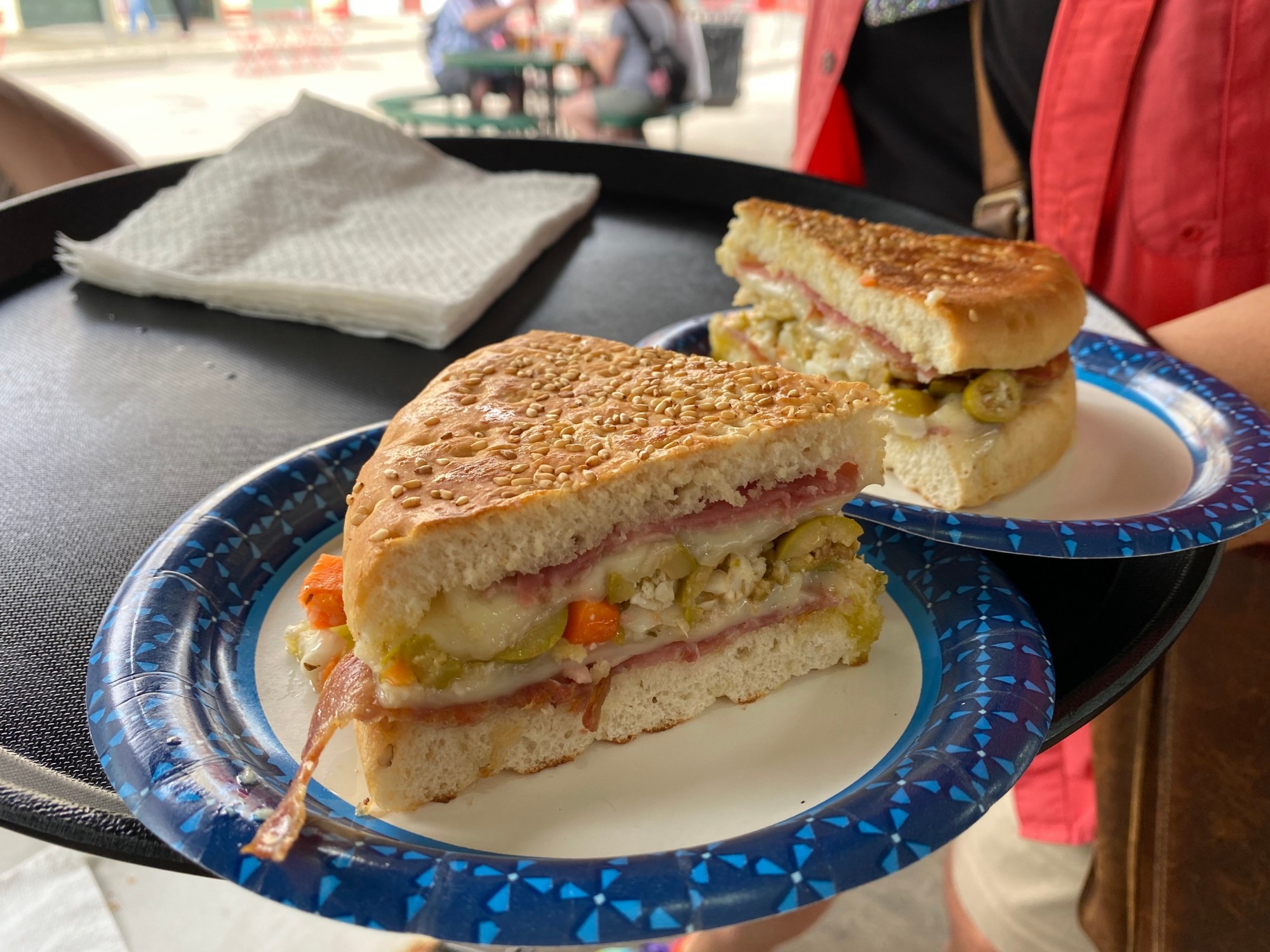 a plate with a cut in half sandwich sitting on top of a table