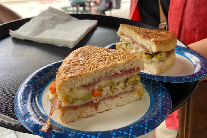 a plate with a cut in half sandwich sitting on top of a table