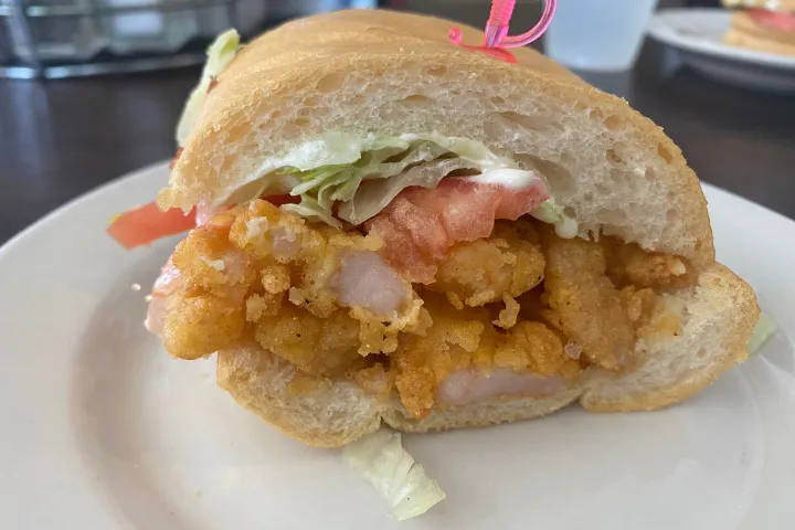 a half eaten sandwich on a plate