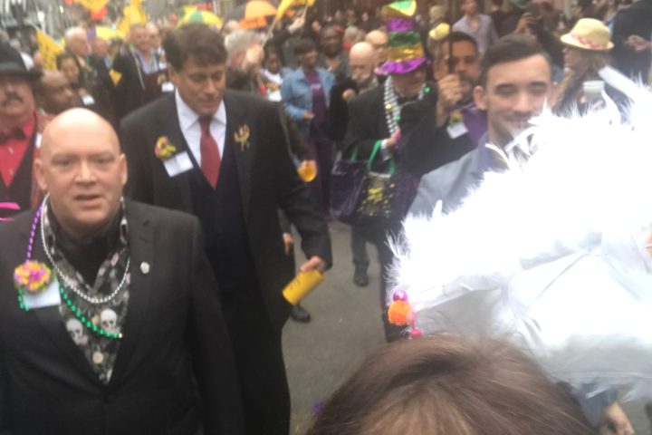 a group of people that are standing in the rain with an umbrella