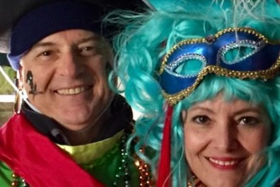 a woman wearing a hat and smiling at the camera