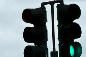 Traffic light showing green near street signs for Prytania and Washington Ave.