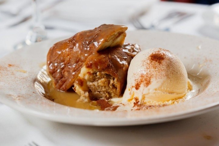 Dessert plate with caramel pudding and vanilla ice cream.